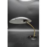 A vintage metal and brass desk lamp with flying saucer shade. H.35 W.50cm Dia.32cm