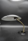 A vintage metal and brass desk lamp with flying saucer shade. H.35 W.50cm Dia.32cm