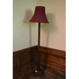 An Art Deco oak standard lamp with it's original shade. H.185cm
