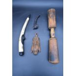 An Eastern carved bone and metal mounted pipe and, a carved hardwood pipe and other carved tribal