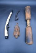 An Eastern carved bone and metal mounted pipe and, a carved hardwood pipe and other carved tribal