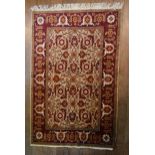 A Ziegler style rug with serrated palm and lotus decoration on a fawn ground within a