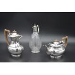 A vintage silver plated coffee pot and the matching teapot and a cut crystal claret jug with