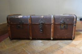 A vintage metal and teak bound travelling trunk. H.35 W.84 D.50cm