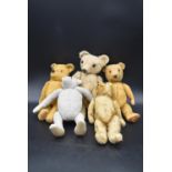 A collection of five teddy bears, four antique one made by Merrythought, with label on the foot. H.