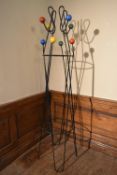 A mid century retro vintage metal floor standing coat stand with multi coloured atomic style coat