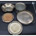 A silver plated twin handled galleried tray, a silver plated bread board and three other silver