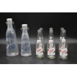 Two vintage milk bottles with stoppers marked; Le bon lait along with six vintage Oscar's