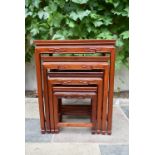 A nest of four Chinese hardwood graduating occasional tables with carved friezes on square