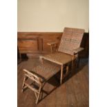A vintage bamboo framed and rattan woven folding veranda armchair fitted with slide out foot rest.