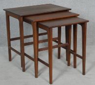 A 1970's vintage teak nest of three graduating occasional tables. H.53.5 L.53.5 W.38cm (Largest)