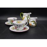 A pair of large Spode floral decorated tea cups and saucers and two Royal Collection jugs. H.14 W.
