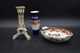 A French faience candlestick, a Mason's Imari style bowl and a 19th century floral decorated vase.