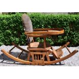 An antique beech framed metamorphic child's high chair converting to rocking chair.