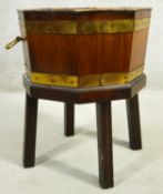 A Georgian mahogany and brass bound wine cooler with twin carrying handles and lift out zinc liner