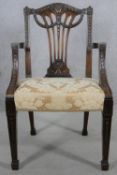 A C.1900 mahogany armchair with carved pierced splat and husk and swag decoration in floral