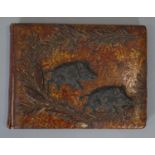 A Meiji period Japanese gilded lacquered and repousse copper work blotter with two wild boars