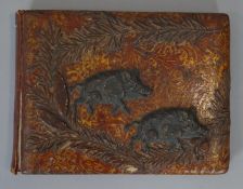 A Meiji period Japanese gilded lacquered and repousse copper work blotter with two wild boars