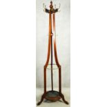 A late 19th century walnut coat and umbrella stand with brass fittings and metal lift out drip tray.