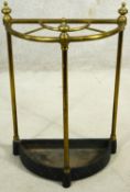 A brass and iron four section umbrella stand of demi lune outline. H.61cm