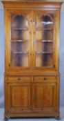 A 19th century style pitch pine two section dresser with glazed upper section above drawers and
