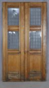 A pair of late 19th century pitch pine exterior doors with leaded windows, taken from the Welsh