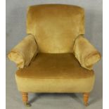 A contemporary Victorian style armchair in velour upholstery on turned supports terminating in cup