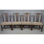 A set of four 19th century mahogany dining chairs with pierced shaped splats above stuff over