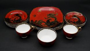 A part New Chelsea Staffordshire gilded hand painted bone china black dragon design on red ground