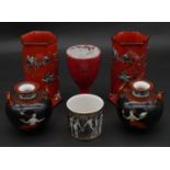A pair of Arcadian ware red glaze hexagonal vases decorated with birds, along with a pair of Grecian