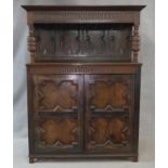 An 18th century country oak court cupboard with stepped moulded cornice and panelled