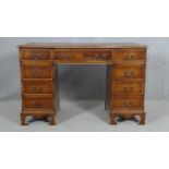 A Georgian style mahogany three section pedestal desk with inset leather top on shaped bracket feet.