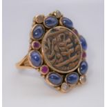 A yellow metal (tested as gold) Islamic coin, sapphire, ruby and diamond dress ring. Set to the