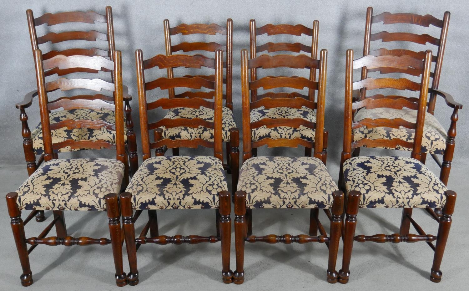 A set of eight oak Lancashire ladderback dining chairs in floral upholstery on turned stretchered