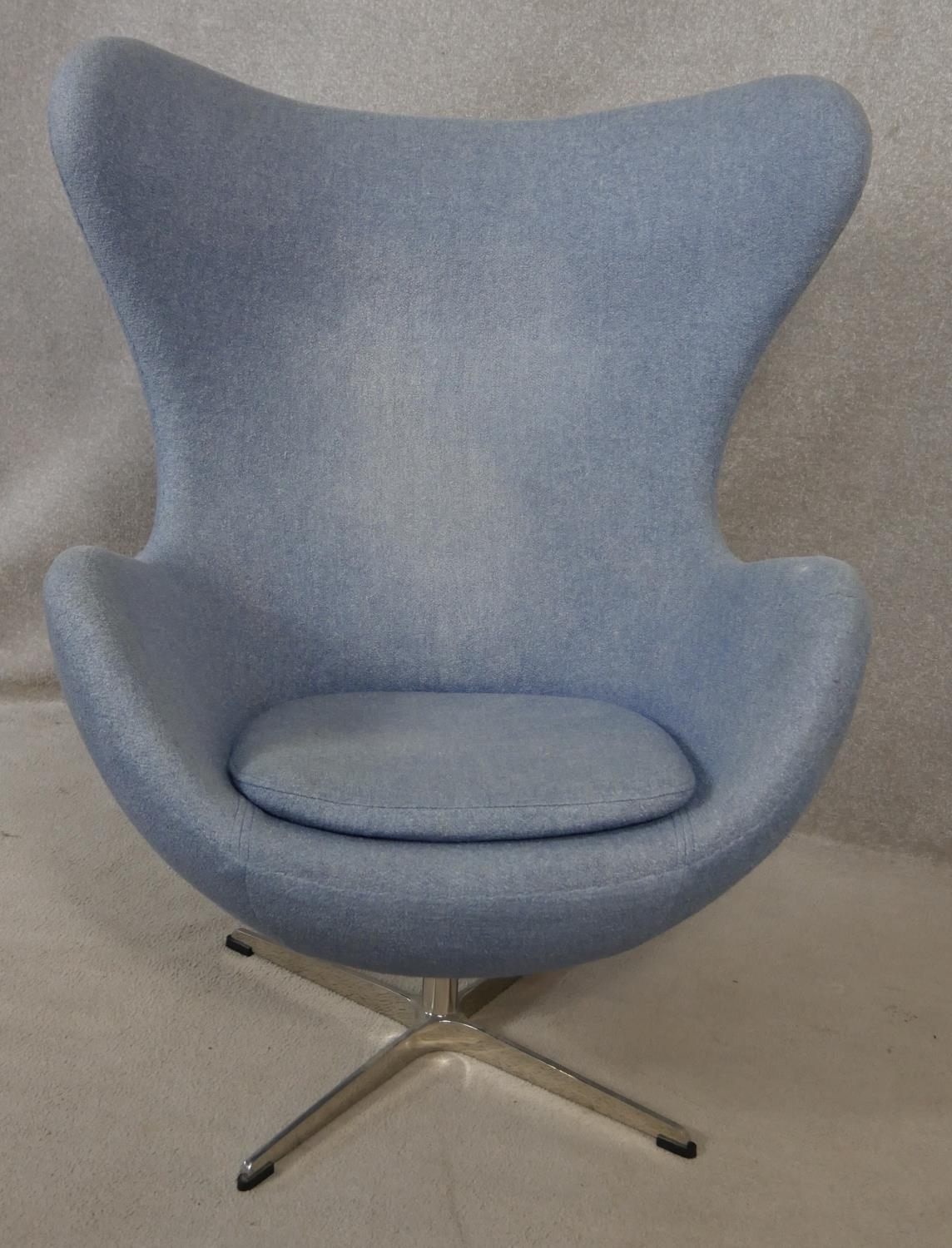 After Arne Jacobsen (1902-1971) Egg chair in pale blue upholstery and rise and fall action on four