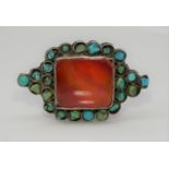 An Oriental silver white metal, Carnelian and Turquoise dress ring. Set to centre with a rectangular