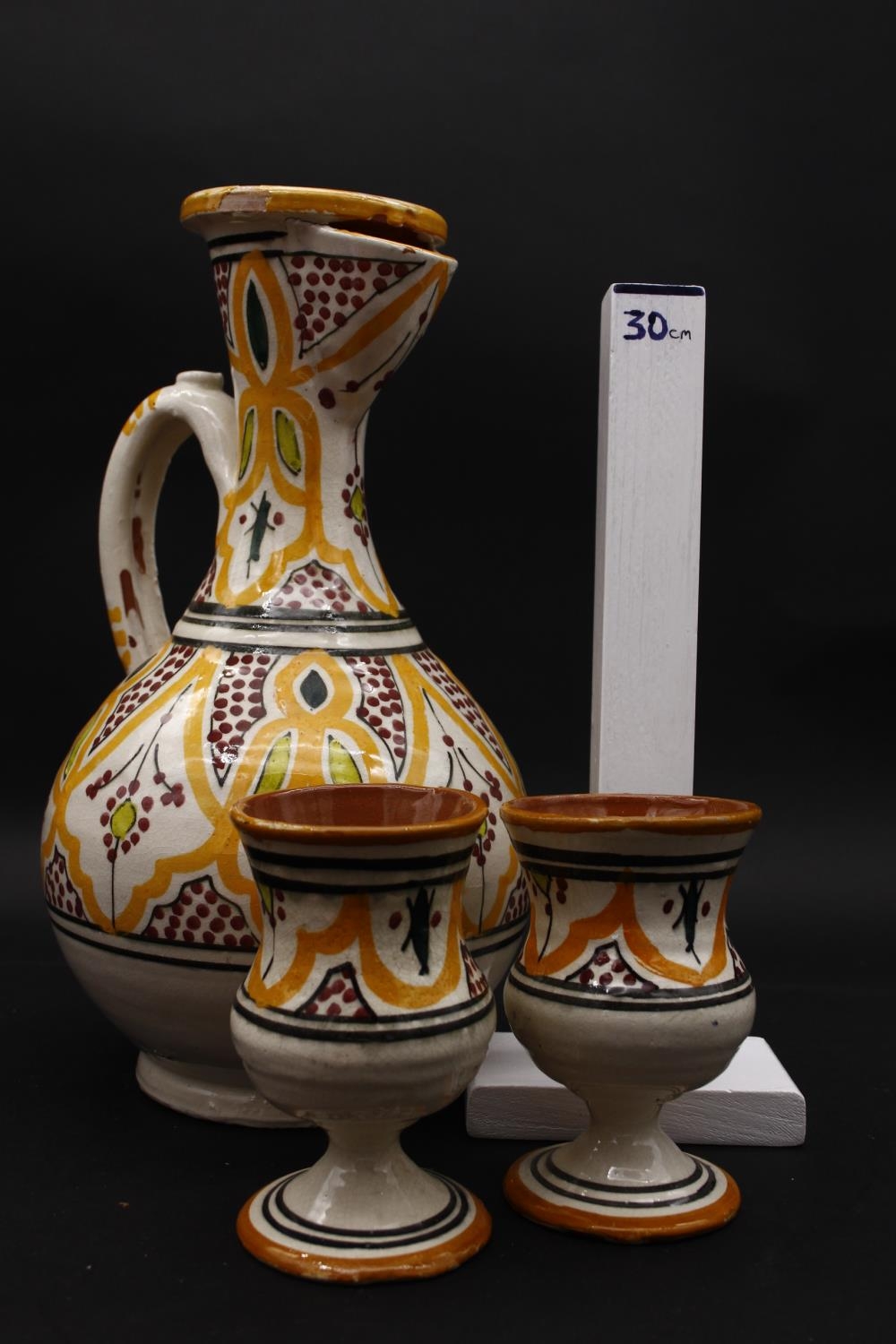 An Islamic glazed hand painted terracotta ewer with stylised foliate and floral design with two - Image 6 of 6