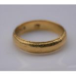 A yellow metal engraved posy ring, engraved to the interior Amor onit omnia (love conquers all)