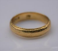A yellow metal engraved posy ring, engraved to the interior Amor onit omnia (love conquers all)