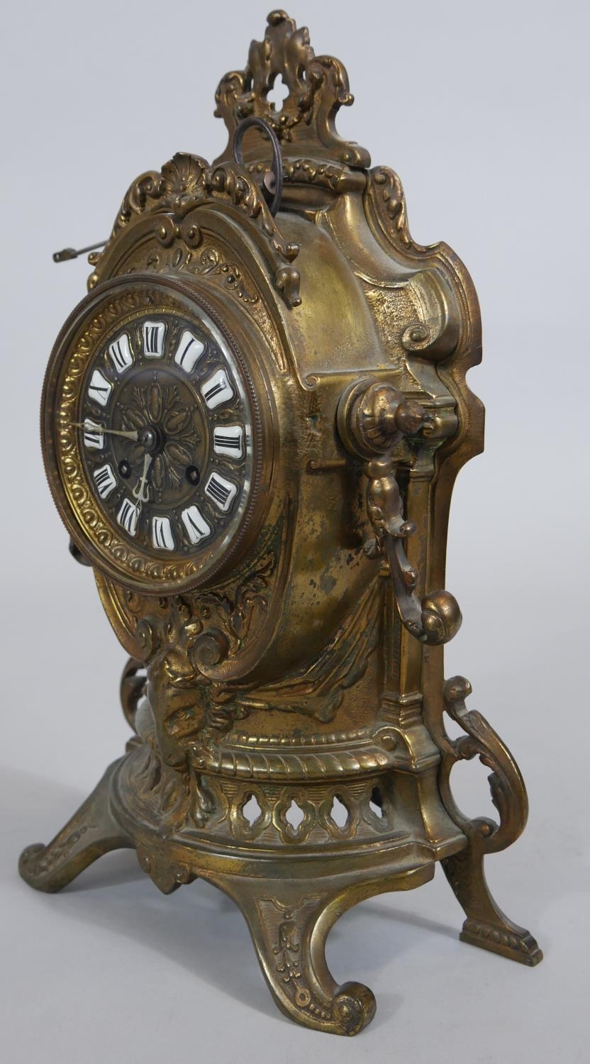 A French style brass mantel clock in scrolling Rococo case with enamel Roman numerals and eight - Image 3 of 7