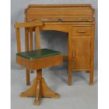 A vintage beech and ply child's desk with tambour roll top and the matching swivel desk chair. H.