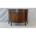 A C.1900 Georgian style mahogany demi lune side cabinet with section veneered and crossbanded top