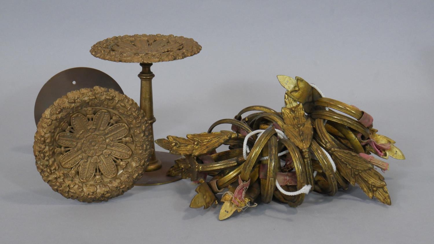 A pair of vintage gilt metal curtain tie backs along with twenty similar leaf form curtain rings.