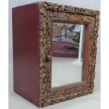 A carved polychrome Eastern teak cabinet with mirrored door. H.43 W.35 D.26cm