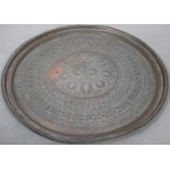 A large brass Eastern engraved tray or table top. D.95cm
