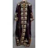A plum velvet embroidered gold thread caftan by Julie Fitzmaurice, with yellow silk lining and