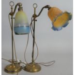 A vintage brass fully adjustable desk lamp with glass shade along with a similar example. H.55cm