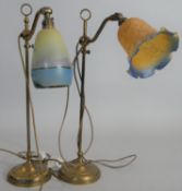 A vintage brass fully adjustable desk lamp with glass shade along with a similar example. H.55cm