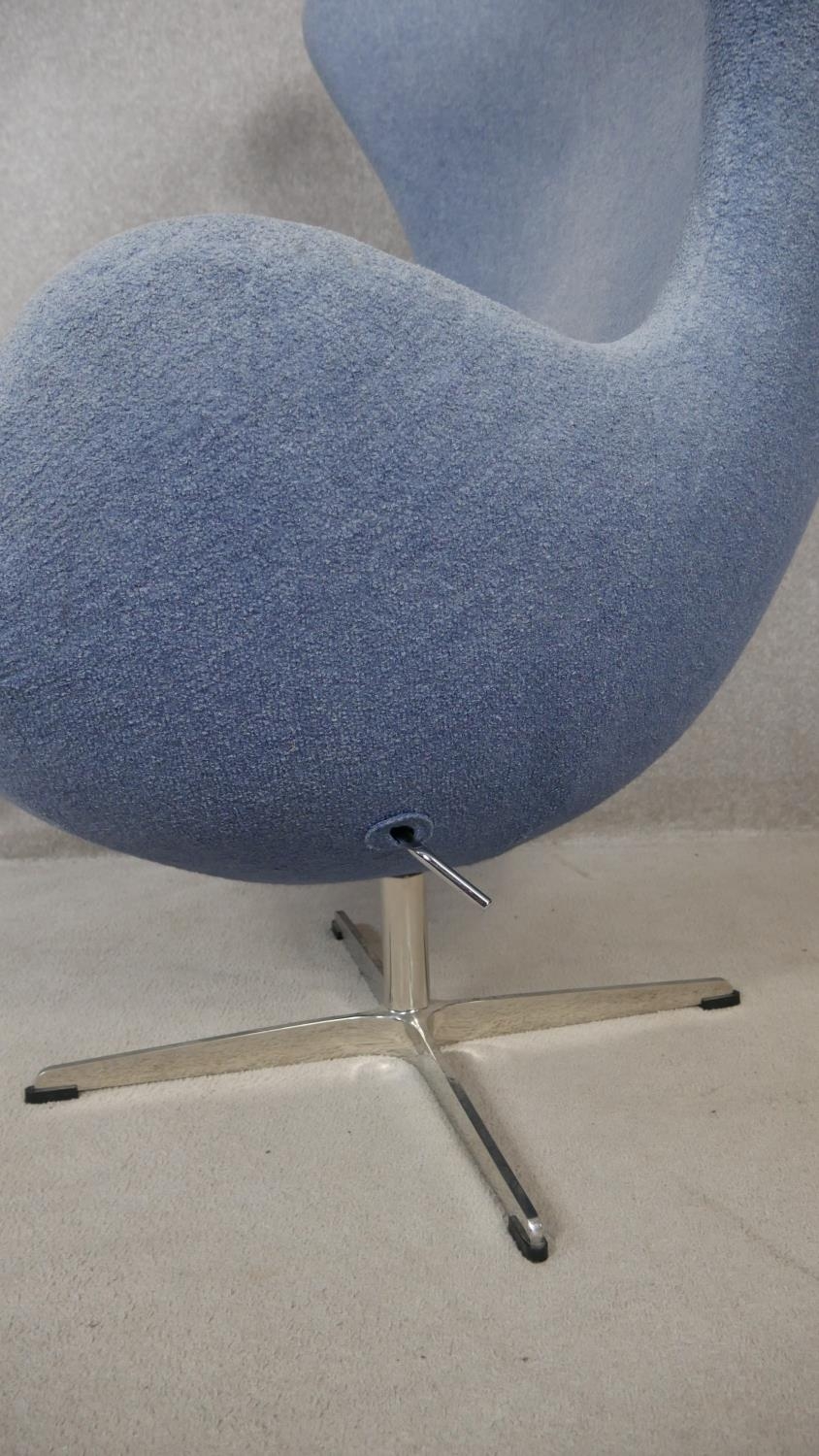 After Arne Jacobsen (1902-1971) Egg chair in pale blue upholstery and rise and fall action on four - Image 4 of 4