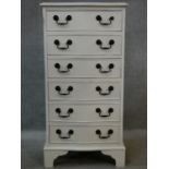 A Georgian style painted narrow chest of six drawers with serpentine front on shaped bracket feet.